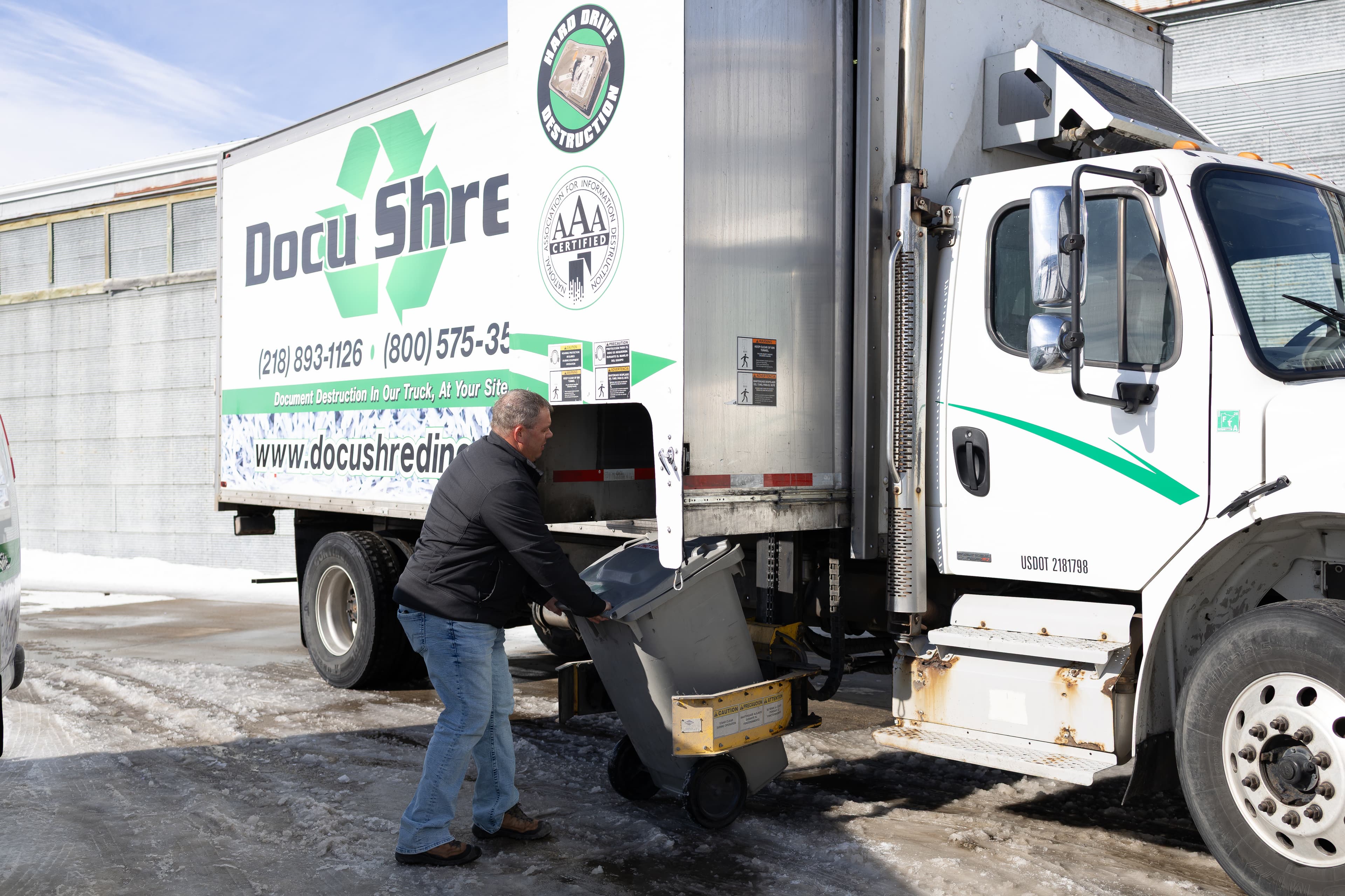 On-site document shredding truck with technician securely disposing of confidential records, demonstrating compliant records destruction and secure service provider operations.